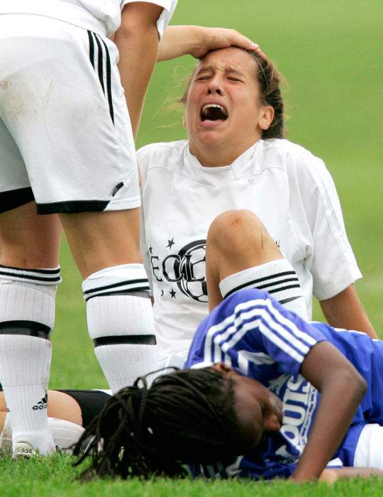 Second Place, Student Photographer of the Year - Michael P. King / Ohio UniversityThe Illinois Eclipse's Chelsea Grant cries out in pain after colliding with St. Louis Soccer Club's Gina Andress (bottom) at the US Youth Soccer Midwest Regional II Championships at USA Youth Sports Complex in Appleton, Wis., June 25, 2006. Comforting Grant is teammate Lindsey Thut. The players involved in the collision continued to play in the game.