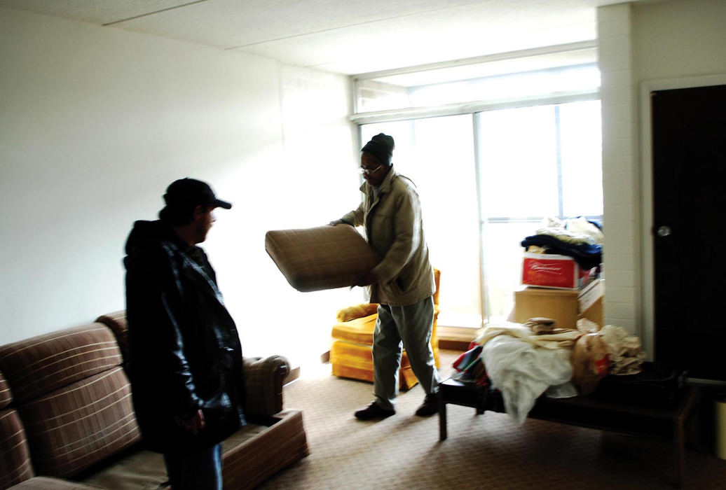 First Place, Student Photographer of the Year - David Foster / Kent State UniversityWith help from Russ, a resident of the group home, Glen arranges his new apartment. 