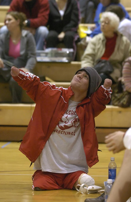 First Place, Sports Picture Story - Jeff Swinger / Cincinnati EnquirerDustin strikes a pose after winning his match at Amelia. Dustin has become a fan favorite for his spirit and attitude.