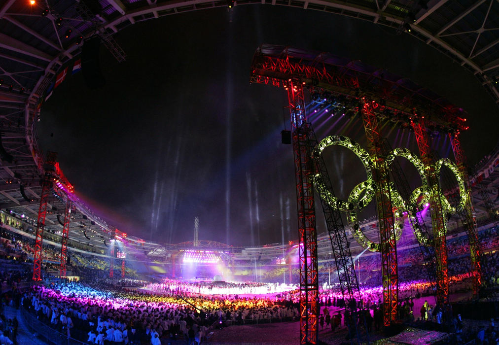 Second Place, Sports Picture Story - Joshua Gunter / The Plain DealerThe motto of the 2006 olympic games- "Passion Lives Here" rang true for the city of Turin as Italy came together to host the winter olympics in style. With true Italian flare, the games went off with lots of color and few problems.The Olympic Rings illuminate the back of the stadium as performers entertain the packed crowd February 26, 2006 at the Stadio Olympico in Turin, Italy. 