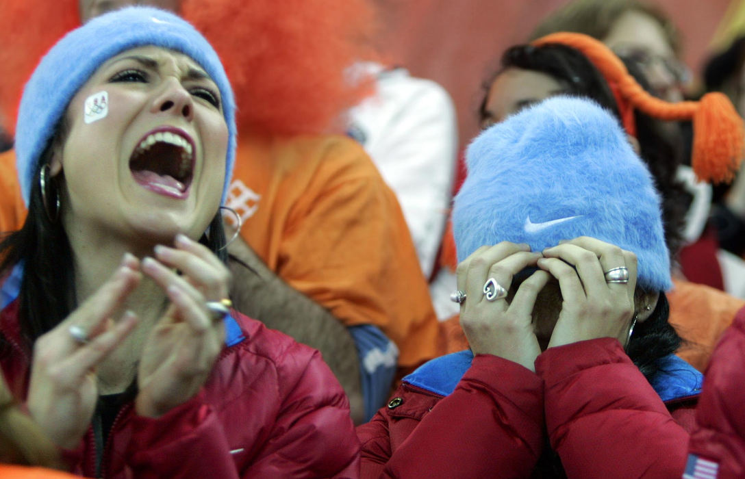 Second Place, Sports Picture Story - Joshua Gunter / The Plain DealerChad Hedrick's sister Lynsey Adams (left) cheers as his other sister Natalie Hedrick can't bear to watch during the men's 10000 M speed skate, February 24, 2006 at Oval Lingotto in Turin, Italy. Hedrick took the silver. 