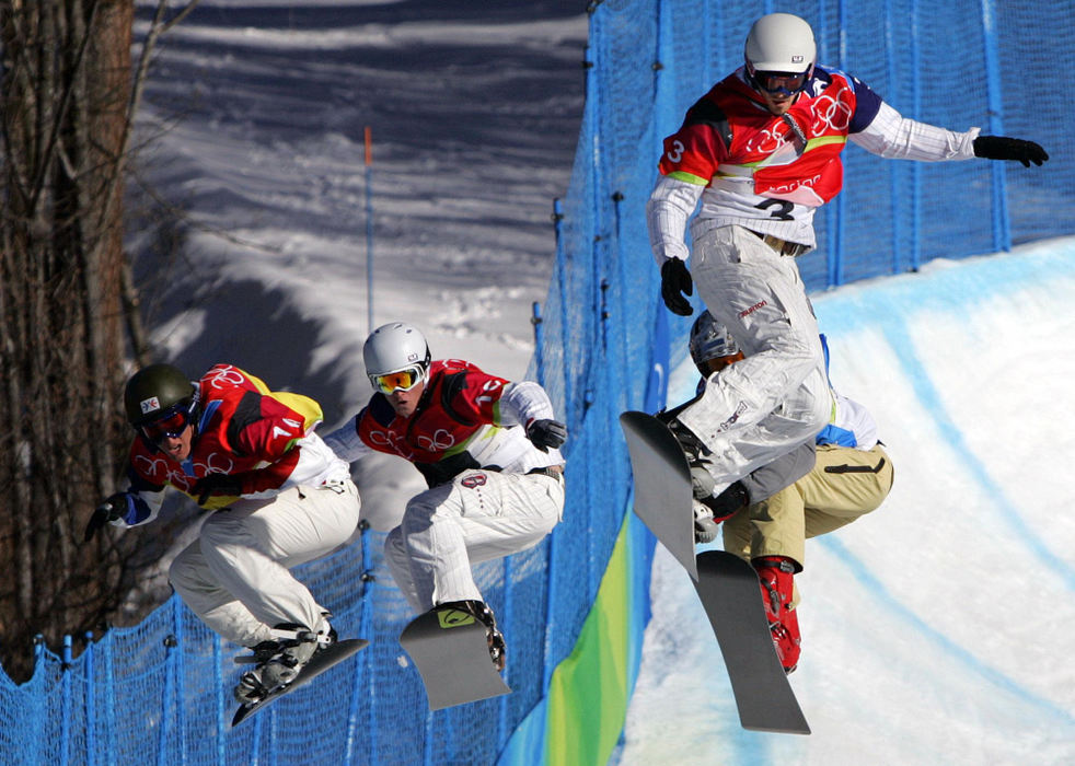 Second Place, Sports Picture Story - Joshua Gunter / The Plain DealerAmerica's Seth Wescott (3) leads the pack over a jump in the semifinals of the men's snowboard-cross competition, February 16, 2006 in Bardoneecchia, Italy. This is the first time the snowboard-cross has been featured in an Olympics. Wescott went onto take the gold. 