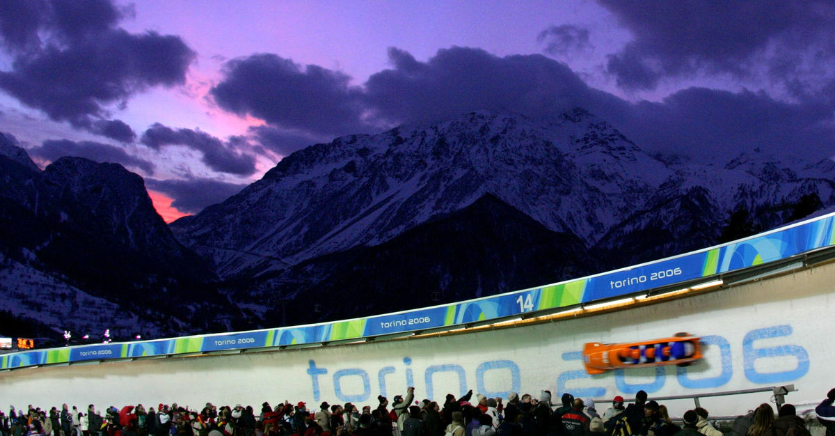 Second Place, Sports Picture Story - Joshua Gunter / The Plain DealerThe Netherland's sled cruises over the fans and under a sunset sky during their first run in the men's four-man bobsled competition, February 25, 2006 in Cesana Pariol, Italy. They finished 16th. 