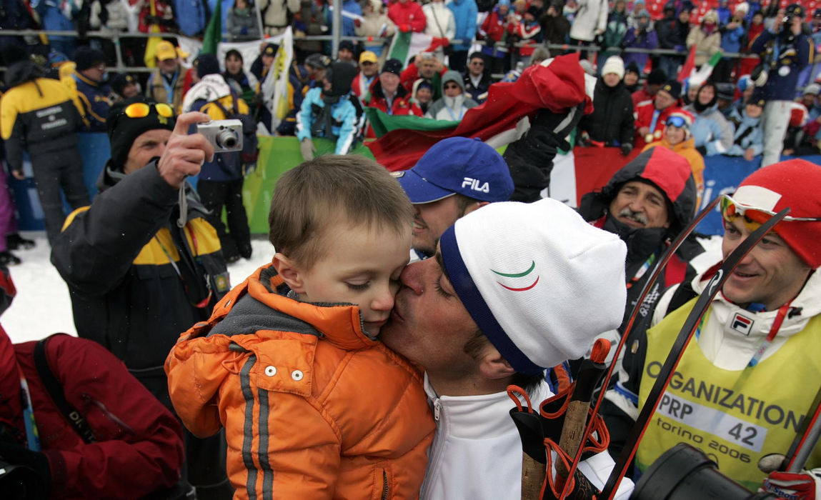 Second Place, Sports Picture Story - Joshua Gunter / The Plain DealerItaly's Pietro Piller Cottrer kisses his son after winning gold in the men's 4x10 km cross-country relay, February 19, 2006 in Pragelato Plan, Italy. Germany and Sweden took silver and bronze respectively. 