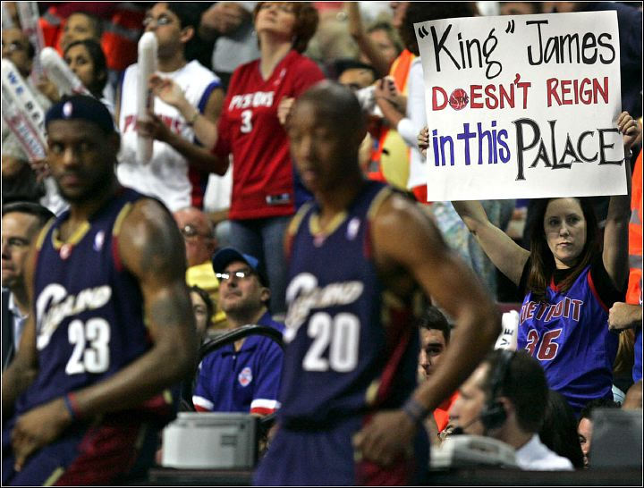 Third Place, Sports Picture Story - Ed Suba, Jr. / Akron Beacon JournalCleveland's LeBron James and Eric Snow stand in front of a Detroit fan holding a sign expressing her opinion during the Cavaliers 113-86 loss to the Pistons in Game 1 of the semifinals of the Eastern Conference playoffs at the Palace in Auburn Hills on  May 7, 2006, in Auburn Hills, Michigan. 