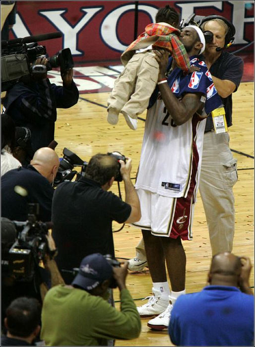 Third Place, Sports Picture Story - Ed Suba, Jr. / Akron Beacon JournalCleveland Cavalier LeBron James kisses his son, LeBron Jr., after helping defeat the Detroit Pistons  86-77 in Game 3 of the semifinals of the Eastern Conference playoffs at Quicken Loans Arena on May 13, 2006, in Cleveland. It was a must-win game that the Cavaliers needed to stay in the series and they proved to be up to the task.