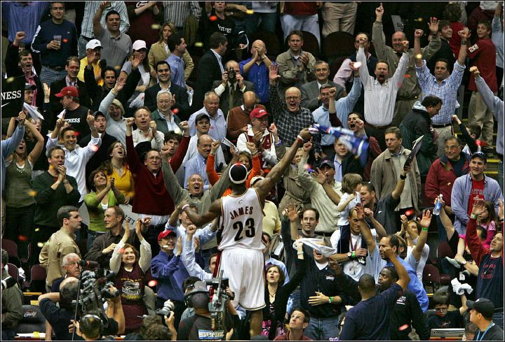 Third Place, Sports Picture Story - Ed Suba, Jr. / Akron Beacon JournalLeBron James stands on the scorers table and celebrates with the crowd after the Cleveland Cavaliers defeated the Detroit Pistons 74-72 in Game 4 of the semifinals of the Eastern Conference playoffs at Quicken Loans Arena on May 15, 2006, in Cleveland. It tied the series at 2 games apiece after the Cavaliers had lost the first two games in Detroit. 