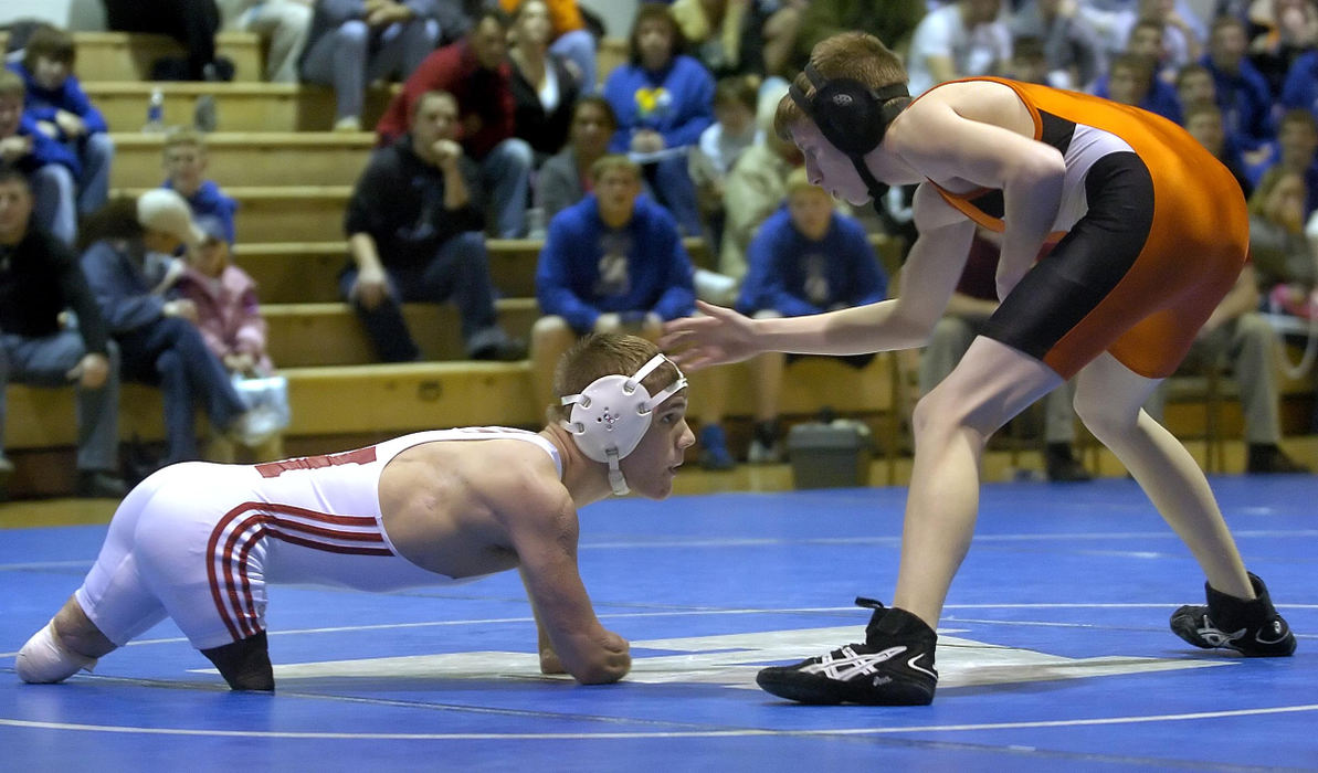 First Place, Sports Picture Story - Jeff Swinger / Cincinnati EnquirerDustin eyes his opponent (right) Ethan Allen from Wilmington High School during their match at Amelia.