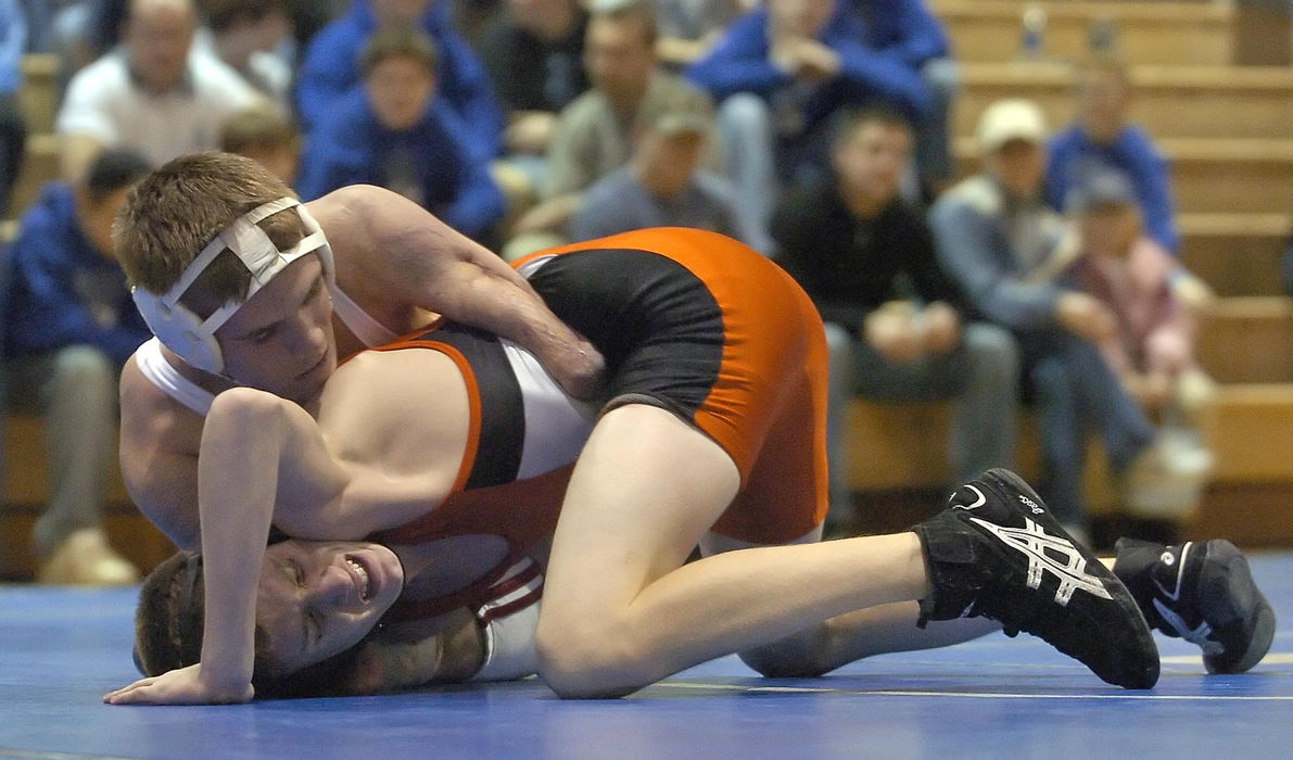 First Place, Sports Picture Story - Jeff Swinger / Cincinnati EnquirerDustin Carter works on his opponent Ethan Allen from Wilmington High School during their match. Dustin won the match on points.