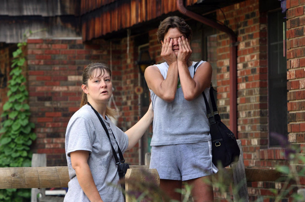 First Place, Team Picture Story - Lynn Ischay / The Plain Dealer"I can't go in there. It's too hard. It hurts too much," cries Deanne Phillipp (right) outside her front door at the flooded Grist Mill apartments in Painesville. It took her an hour to work up the courage to enter her home, two days after flooding hit the area.  Neighbor Kathleen Fields, left, tries to comfort Phillipp. Residents of Grist Mill and Mill Creek were allowed back into their homes for an hour to collect what they could, at their own risk. 
