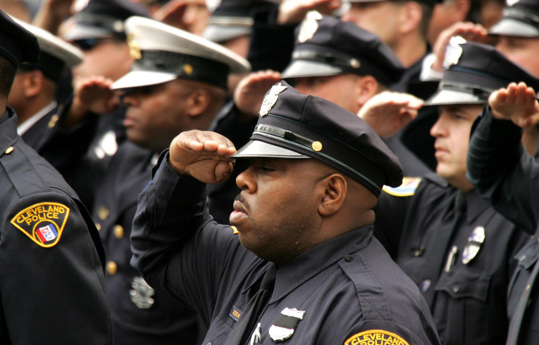 Second Place, Team Picture Story - DALE OMORI / The Plain DealerPolice officers from throughout the area stand in formation and salute.