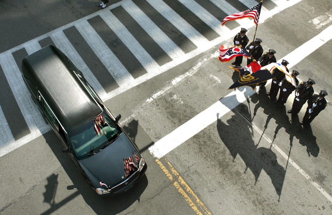 Second Place, Team Picture Story - chuck crow / The Plain DealerAn honor guard stands at attention as the hearse leaves after the funeral Mass Wednesday. 