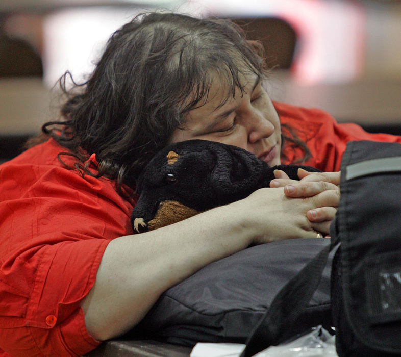 First Place, Team Picture Story - Roadell Hickman / The Plain DealerKate Moore finds a little comfort at Harvey High School, a staging area for the Red Cross and a relief area for Painesville flood victims on July 28.  Moore had to evacuate her apartment when more than 10 inches on rain flooded the area.