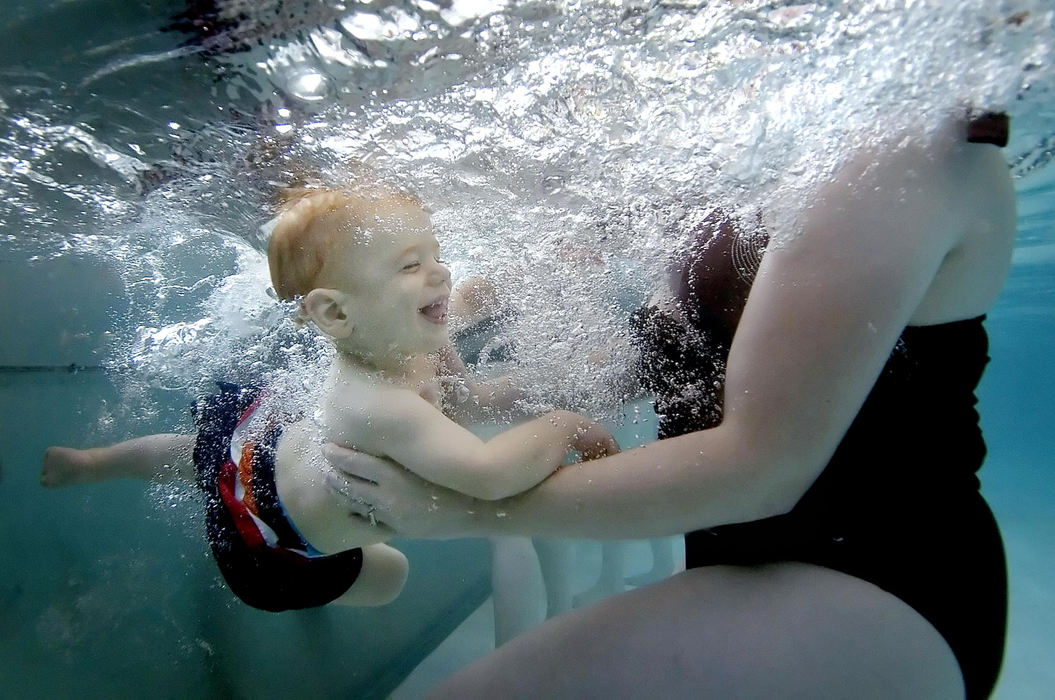 First Place, Assigned Feature - Andy Morrison / The BladeZachary Hemry, 17 months-old, dives underwater as his mother Jennifer Hemry, Temperance catches him during an infant aquatic class at the Temperance Family YMCA, July 3, 2007.