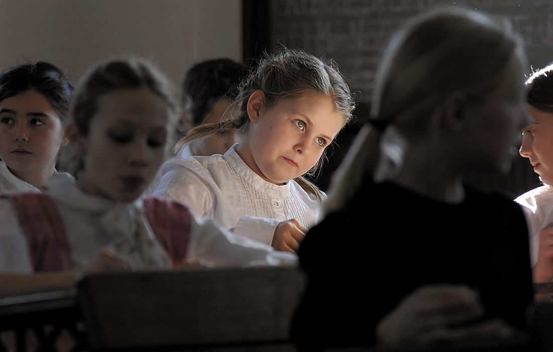 Third Place, Assigned Feature - Tim Johnson / Suburban News PublicationsSunlight catches the intent gaze of Natalie Webb as she works on a class assignment in the 1860s schoolhouse at the Ohio Historical Society where Edison Intermediate-Middle School fifth-graders had lessons.