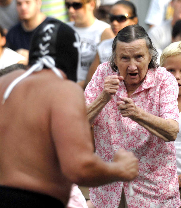 Award of Excellence, Assigned Feature - Bill Lackey / Springfield News-SunNinety-year-old Dorothy Brown is ready to take on a professional wrestler called the "Sheek of Arabi" as she gets carried away by the action at the Champaign County Fair in Urbana. Brown is a regular ringside attraction at the annual wresting event.  