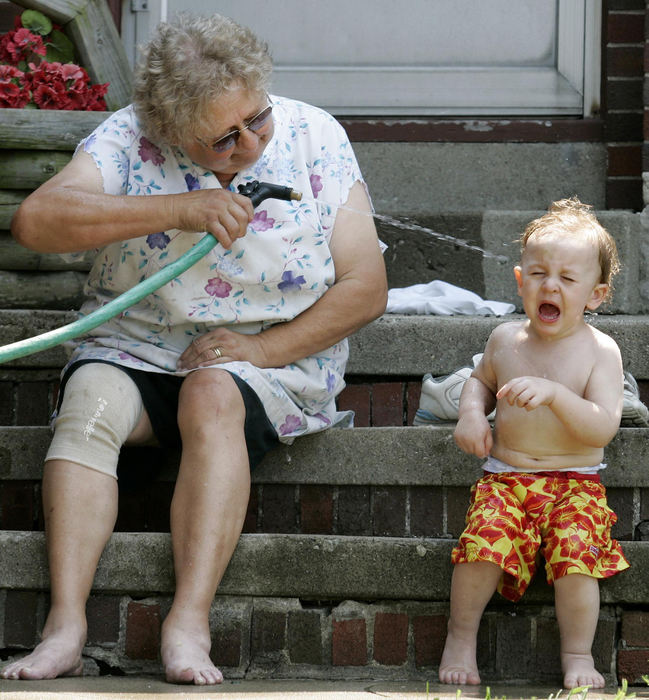 Award of Excellence, Enterprise Feature - Dave Zapotosky / The BladeAshton Alexander, 2, was less than thrilled when his great grandmother Maxine Strunk attempted to cool him off in East Toledo.  