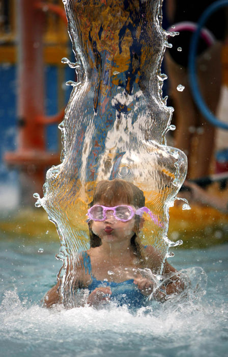 Award of Excellence, Enterprise Feature - Tracy Boulian / The Plain DealerSamantha Gulley, 4, of Bay Village, cools off in a cascade of water as she joins many others in the water playground at the Bay Village Family Aquatic Center during sizzling 94-degree weather on July 9, 2007.