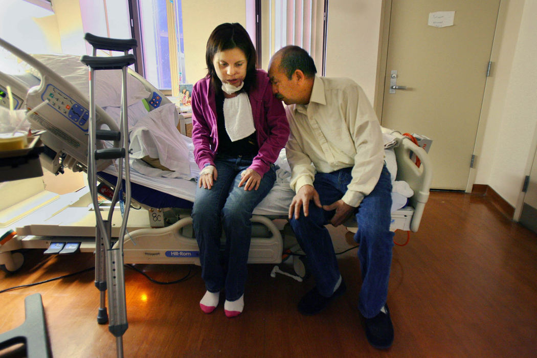Second Place, Feature Picture Story - Gus Chan / The Plain DealerJohanna gets a kiss from her grandfather, Wosbely, while waiting for Dr. Michael Fritz to come by to discharge her.  