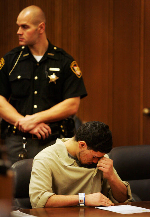 Second Place, Feature Picture Story - Gus Chan / The Plain DealerJuan Ruiz wipes away tears before pleading guilty to all charges of rape and attempted aggravated murder in the shooting of his former girlfriend, Johanna Orozco.  