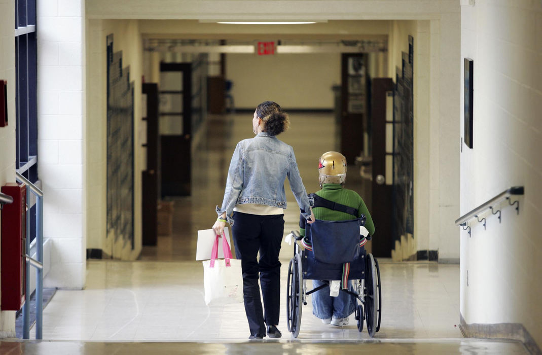 Third Place, Feature Picture Story - Shari Lewis / The Columbus DispatchSpecial-education aide Heather Miller helped Rachel return to Thomas Worthington High School in mid-December. Rachel was primarily using a wheelchair until May.