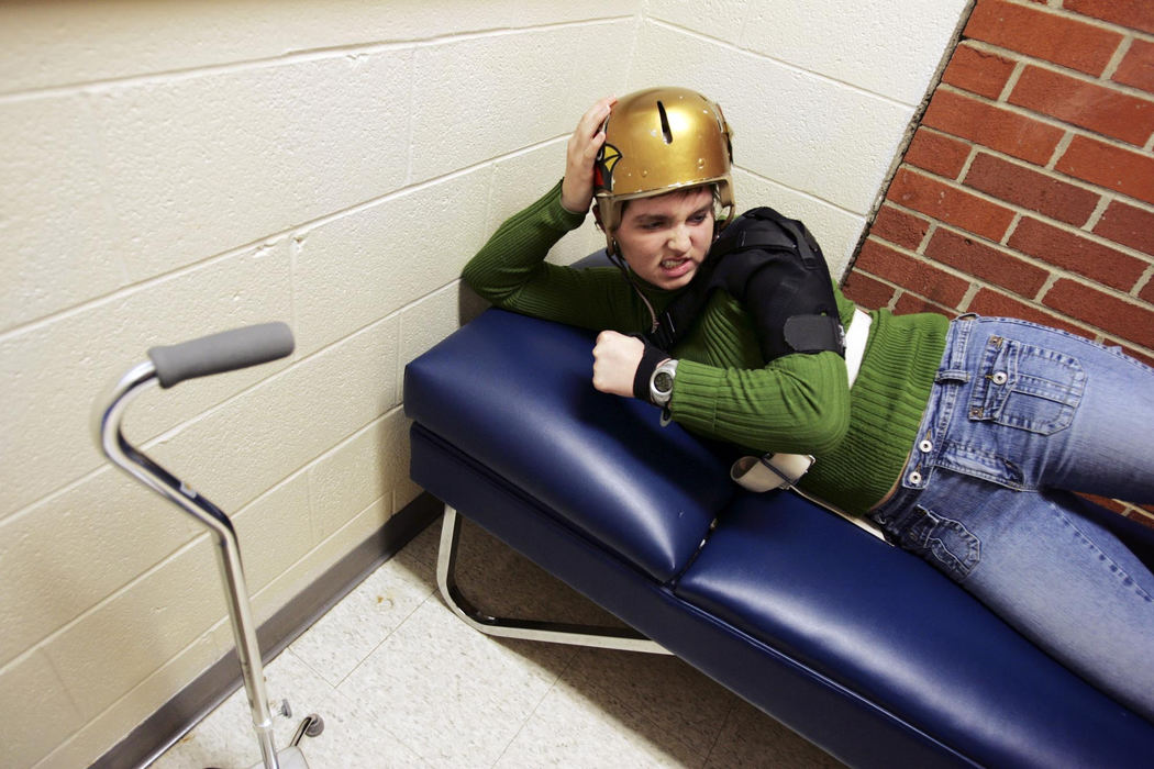 Third Place, Feature Picture Story - Shari Lewis / The Columbus DispatchRachel pushes herself to strengthen her left leg by doing leg lifts during physical therapy. For the seven months until her skull was repaired, she wore a helmet virtually all the time. 