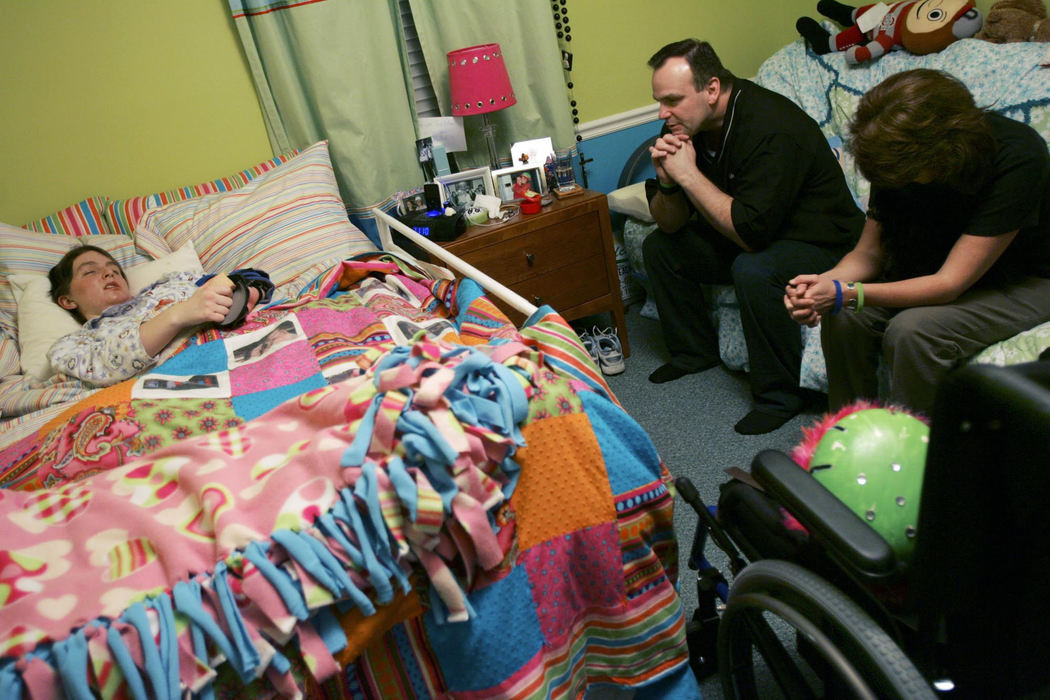 Third Place, Feature Picture Story - Shari Lewis / The Columbus DispatchRachel  with her father Greg Barezinsky and stepmother Drue Barezinsky before going to bed. "I pray for Allen Davis, that he will get better and realize what he did is wrong," Rachel said. "I would forgive him if he said, 'Sorry,' but he hasn't done that." 
