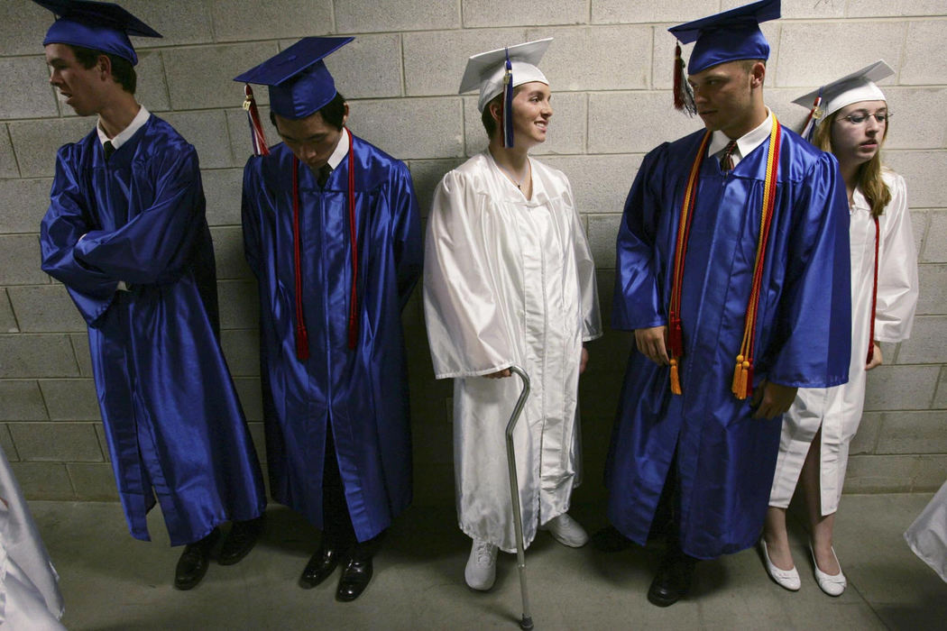 Third Place, Feature Picture Story - Shari Lewis / The Columbus DispatchRachel lines up for commencement with fellow Thomas Worthington High School seniors, from left, Benjamin Bacon, Jihyun Bang, Patrick Barren, and Elizabeth Barnette. For Rachel, the Thomas Worthington commencement was a victory over the bullet in her brain. "I made it through high school," she declared. "And I'm ALIVE!"
