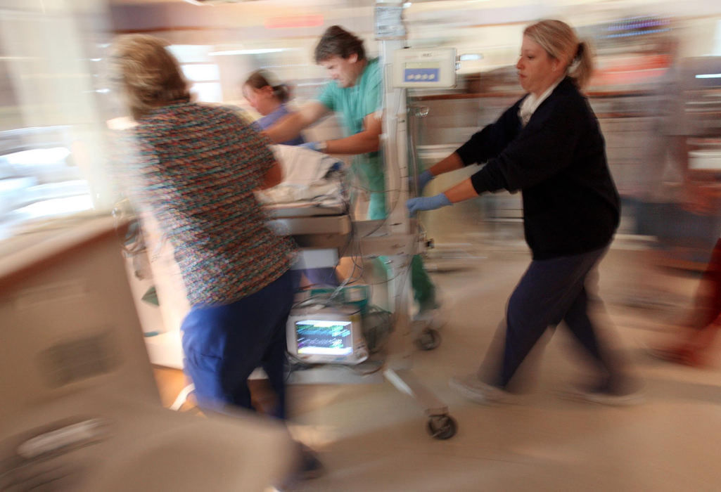 First Place, Feature Picture Story - Chris Russell / The Columbus DispatchA team of nurses and technicians race Riley to an operating room for laser surgery on his eyes.  The general anaesthetic is a health risk to his fragile system and he must be off supplemental oxygen during the procedure. 