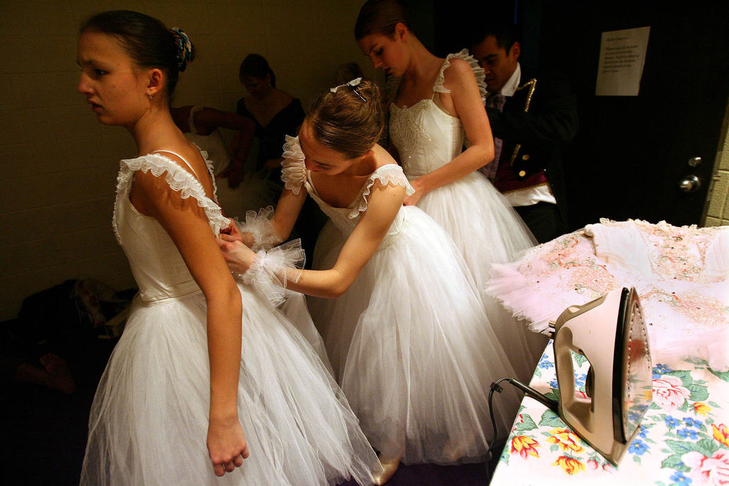Award of Excellence, Feature Picture Story - Lisa DeJong / The Plain Dealer  From left, Christina Wiley, 14, of Avon Lake, Kasha Hilton, 15, of Oberlin and Breanna Wisnor, 16, of Norwalk, help each other with their quick changes for the next scene which they play "snow'  during dress rehearsal for the Nutcracker.