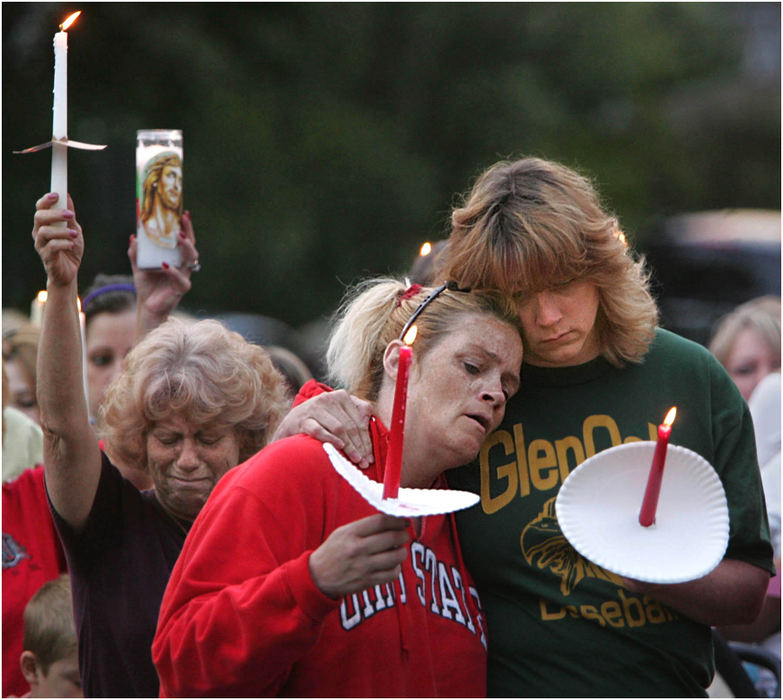 Award of Excellence, General News - Ed Suba Jr / Akron Beacon JournalMary Domer of Springfield Township, Jene Michalek of Canton, and Kim Shoup of Uniontown, stand with a group of around 250 friends and neighbors who gathered to honor the memory of Jessie Marie Davis during a candlelight vigil at the Davis home. Davis' disappearance and the discovery of her body buried in park 3 days later after her boyfriend, Canton, Ohio police officer Bobby Cutts Jr. confessed, was national news for nearly two weeks. 
