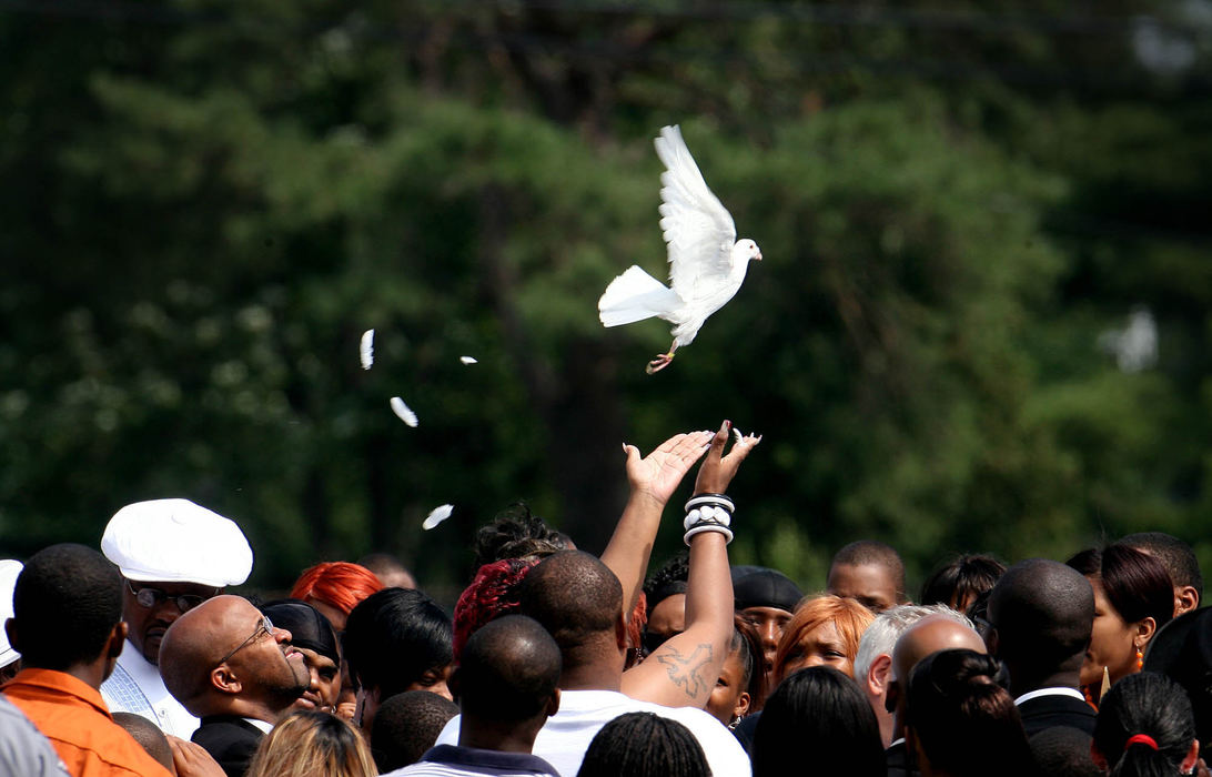 Award of Excellence, General News - Lisa DeJong / The Plain DealerKim Elliot, mother of Asteve' "Cookie" Thomas, releases a dove near her daughter's grave site at Evergreen Memorial Park Cemetery. “It could have been your little sister, it could have been your baby, it could have been anybody, " Elliot said. 