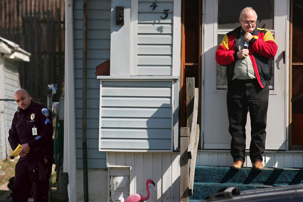 Second Place, News Picture Story - Phil Masturzo / Akron Beacon JournalAn Akron police officer keeps an eye on Alexander Campbell, 55, as he holds a knife to his throat at his home on Idaho Avenue during an hour-long standoff in his front yard. Before police arrived, Campbell used a Louisville Slugger to smash the vehicle of his estranged wife, Candy, prior to pulling the knife on her and himself. The standoff ended when Campbell was tasered and placed into custody. 