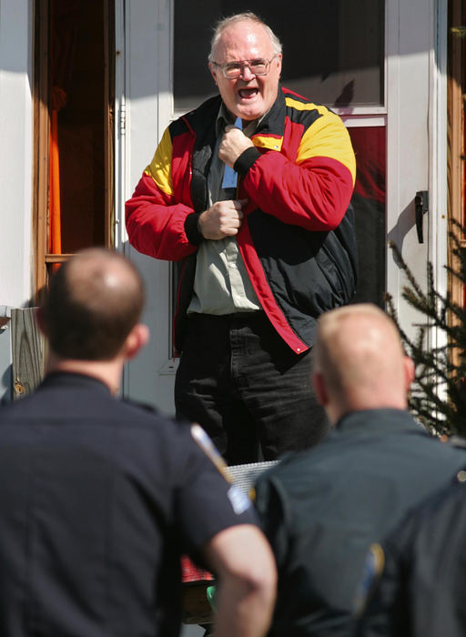 Second Place, News Picture Story - Phil Masturzo / Akron Beacon JournalAkron police officers talk to Alexander Campbell, 55, as he holds a knife to his throat at his home during an hour-long standoff. The standoff ended when Campbell was tasered and placed into custody. 