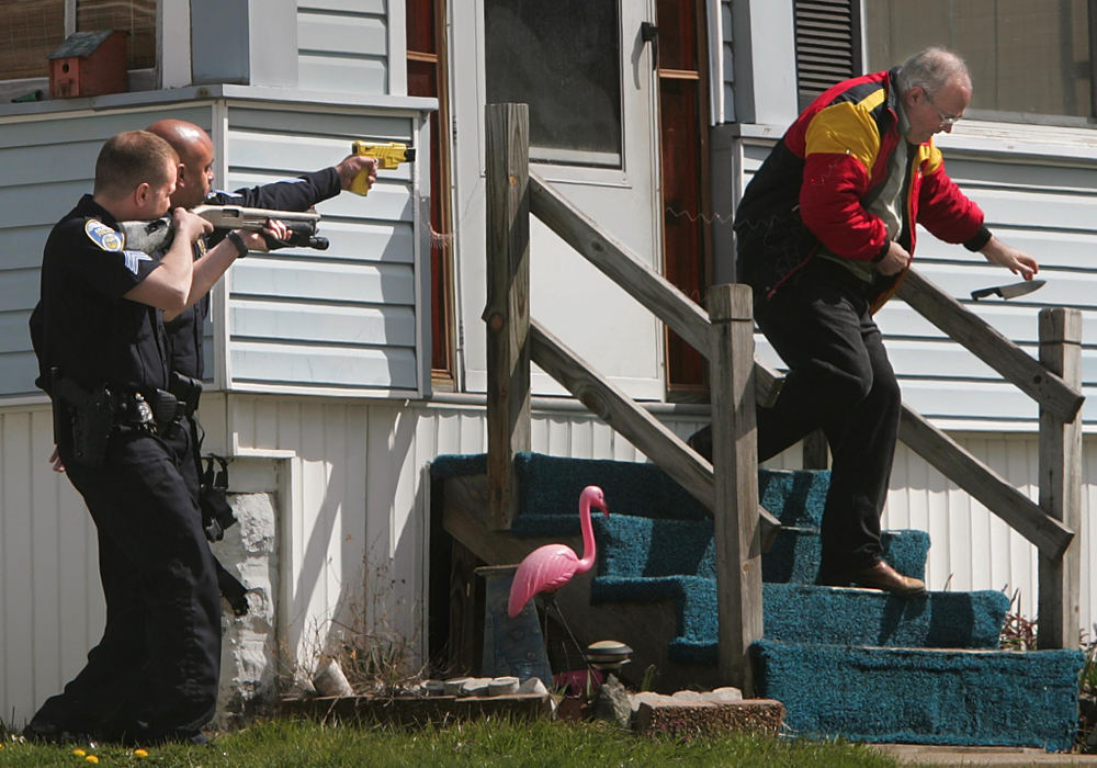 Second Place, News Picture Story - Phil Masturzo / Akron Beacon JournalAkron police officers subdue Alexander Campbell, 55, with a taser forcing him to drop his knife after an hour-long standoff. 