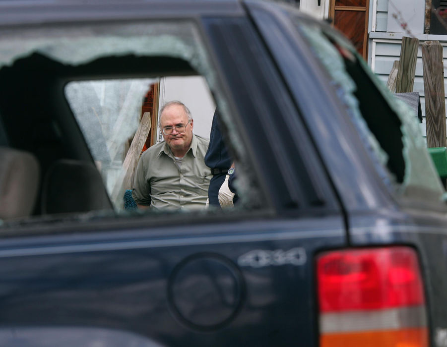 Second Place, News Picture Story - Phil Masturzo / Akron Beacon JournalAlexander Campbell, framed in a window of his estranged wife's Jeep, waits to be transported by the Akron police. Campbell smashed the vehicle with a Louisville Slugger prior to pulling a knife on his wife and himself, which led to a hour-long standoff with Akron police. The standoff ended when Campbell was tasered and placed into custody. 