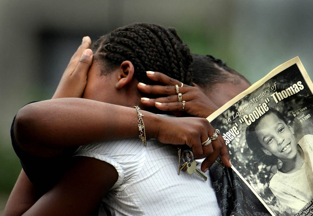 Third Place, News Picture Story - Lisa DeJong / The Plain DealerSchoolmates of Asteve' Thomas cry as they walk out of the Thomas'  funeral service at Mount Sinai Baptist Church. Asteve' "Cookie" Thomas, 12,  was shot and killed, an innocent bystander caught in the crossfire of suspected drug peddlers, as she walked home from a candy store on Francis Avenue. Cleveland accounted for more than half of the homicides in the region, reporting 132 homicides this year. James Yhonquea, 20, of Cleveland, has been charged with aggravated murder. 