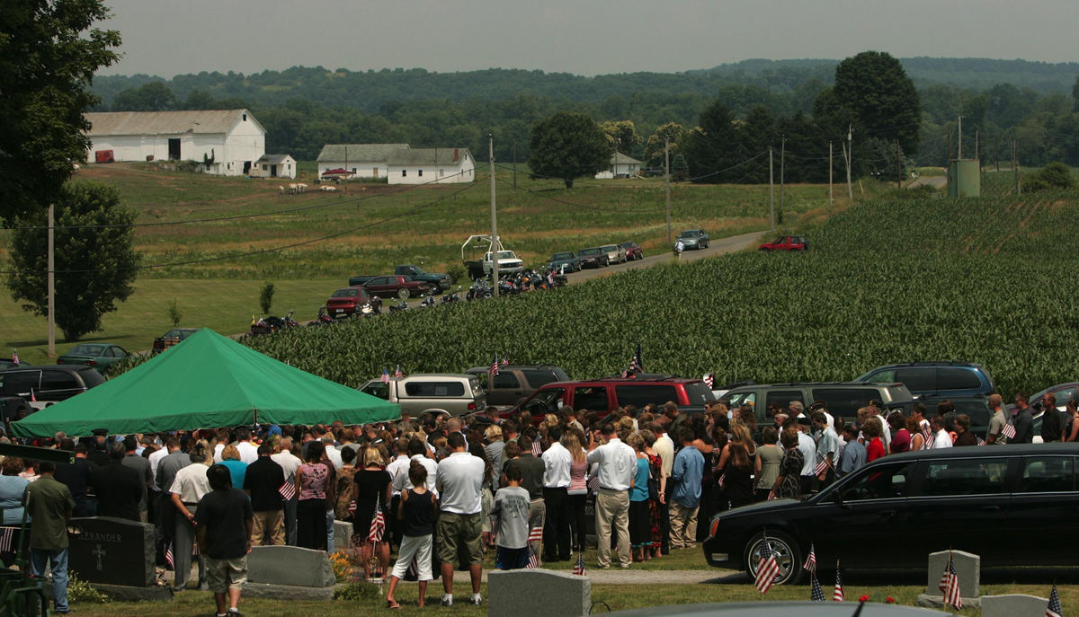 Award of Excellence, News Picture Story - Ken Love / Akron Beacon JournalHundreds of mourners attend the funeral of U.S. Army Cpl. Zachary A. Grass, 22, at Welty Cemetery  in Sugarcreek. The Fairless High School graduate's funeral services were held at the High School. 