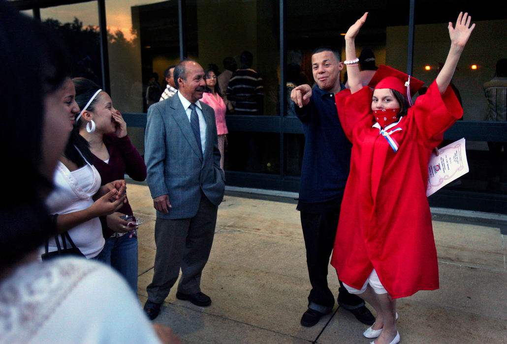 First Place, James R. Gordon Ohio Understanding Award - Gus Chan / The Plain DealerJohanna raises her arms in celebration after graduation.  