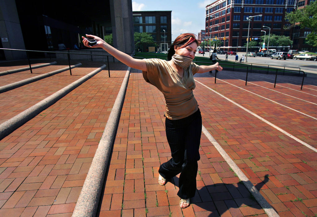 First Place, James R. Gordon Ohio Understanding Award - Gus Chan / The Plain DealerJohanna Orozco raises her arms in relief as she leaves the Justice Center after ex boyfriend Juan Ruiz pled guilty to all charges.  