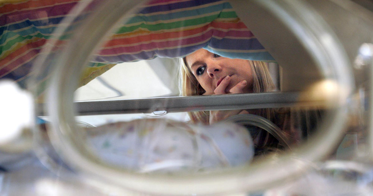 Second Place, James R. Gordon Ohio Understanding Award - Chris Russell / The Columbus DispatchRiley's mother, Beth Potter views her son Riley from the unopened port in his incubator during a visit to Children's Hospital in early May.  She would not get to touch him or hold him for several months.  