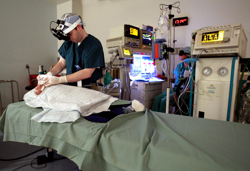 Second Place, James R. Gordon Ohio Understanding Award - Chris Russell / The Columbus DispatchIn an under lit operating room, Dr. Rick Golden will make about 1000 laser cuts on each of Riley's eyes to treat for retinopathy of prematurity.  He must cut the abnormal blood vessels that grow and spread throughout the retina.  