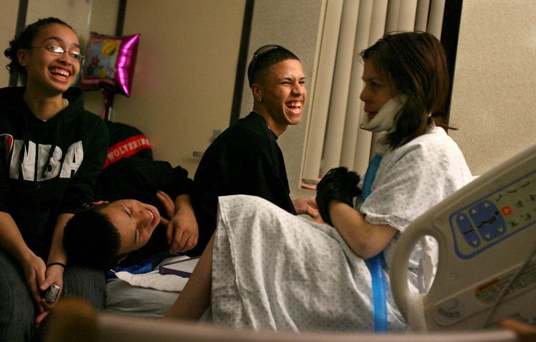 First Place, James R. Gordon Ohio Understanding Award - Gus Chan / The Plain DealerWhile waiting days for her surgery, Johanna Orozco never loses her sense of humor as she jokes with friends on a Friday night  at MetroHealth.