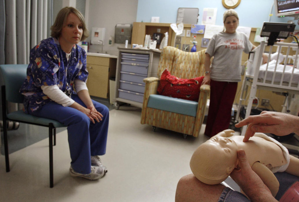 Second Place, James R. Gordon Ohio Understanding Award - Chris Russell / The Columbus DispatchAfter spending a stressful day by herself trying to learn all about Riley's at home care needs, Beth and John decide to spend all night at the hospital to get a crash course in his needs.  Here John demonstrates his knowledge of infant CPR to an RN and Beth. 