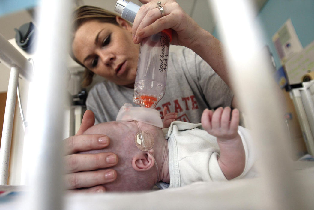 Second Place, James R. Gordon Ohio Understanding Award - Chris Russell / The Columbus Dispatch Beth learns how to administer  a treatment that helps Riley with his breathing.  They will leave the hospital in the morning with a full time monitor, oxygen and a regimen of drugs and treatments for him. 