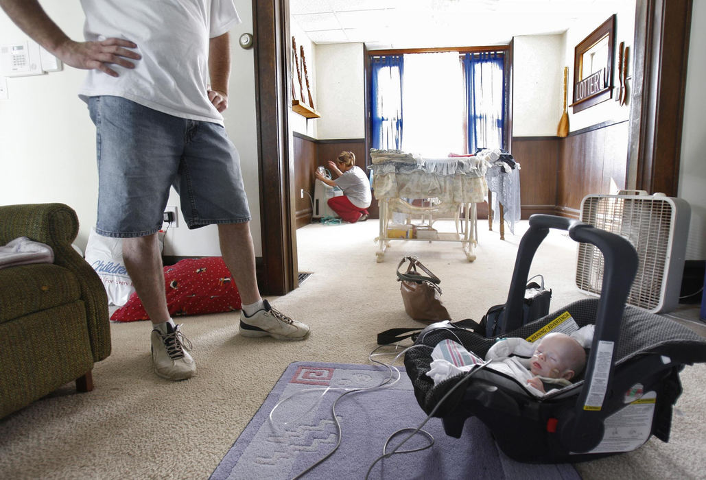 Second Place, James R. Gordon Ohio Understanding Award - Chris Russell / The Columbus DispatchJohn stares at the new arrival while Beth readies the respiratory equipment  that Riley will need to stay alive.  