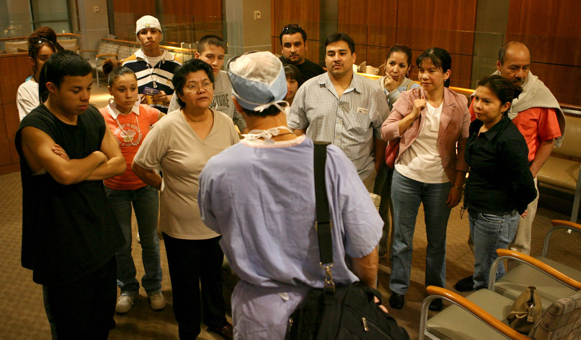 First Place, James R. Gordon Ohio Understanding Award - Gus Chan / The Plain DealerDr. Michael Fritz addresses more than a dozen members of Johanna Orozco's family after finishing a thirteen hour surgery to replace her lower jaw. 