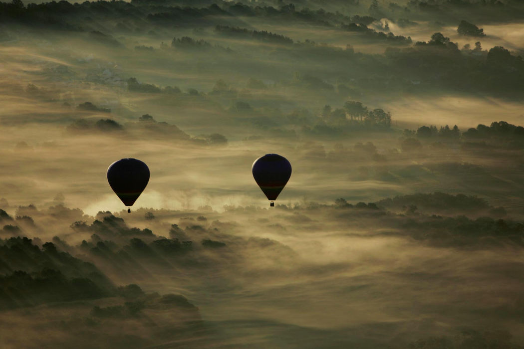 Third Place, Pictorial - Paul Tople / Akron Beacon JournalTwo balloonists skim across fog covered land on Sept. 29, 2007 in Akron.