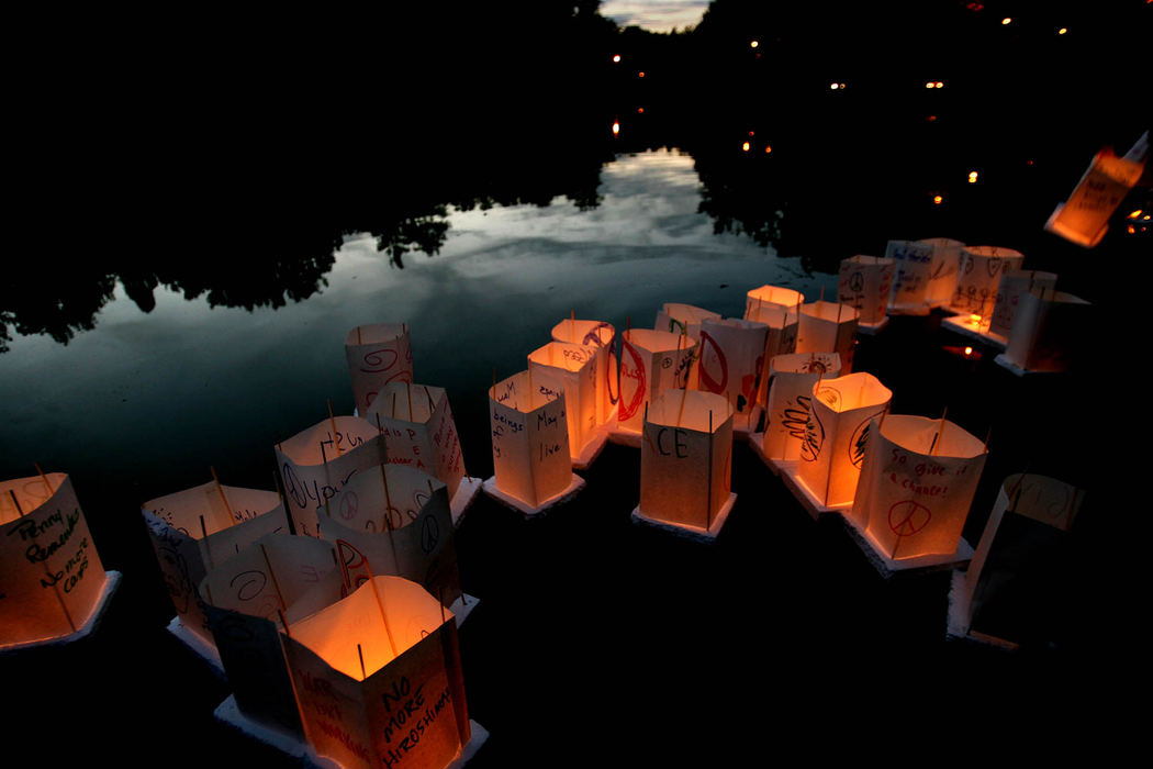 Award of Excellence, Pictorial - Lisa DeJong / The Plain DealerLanterns with messages of peace float at dusk to comfort the souls of atomic bomb victims who died August 4, 1945, in Hiroshima, Japan. Cleveland Peace Action sponsored the event  "The Commemoration of Hiroshima Day" on the pond at Rockefeller Park marking the 62nd anniversary of the world's first atomic bombing. Hiroshima Day is observed throughout the world to honor the over 200,000 people killed in the bombings of Hiroshima and Nagasaki, most of those civilians. 