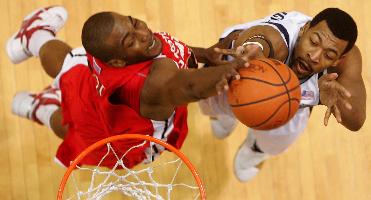 Award of Excellence, Photographer of the Year - Ken Love / Akron Beacon JournalYoungstown State's Jack Liles (left) blocks a shot by University of Akron's Chris McKnight at the James A. Rhodes Arena in Akron.